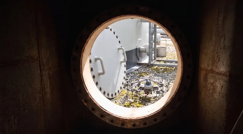 Open manway hatch on an industrial tank